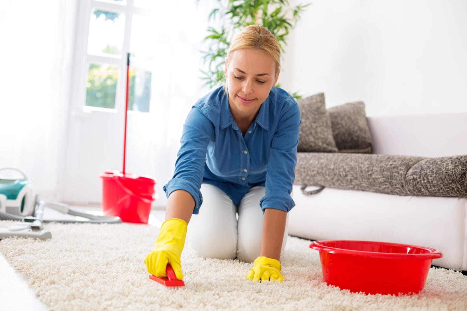 woman cleaning area rug