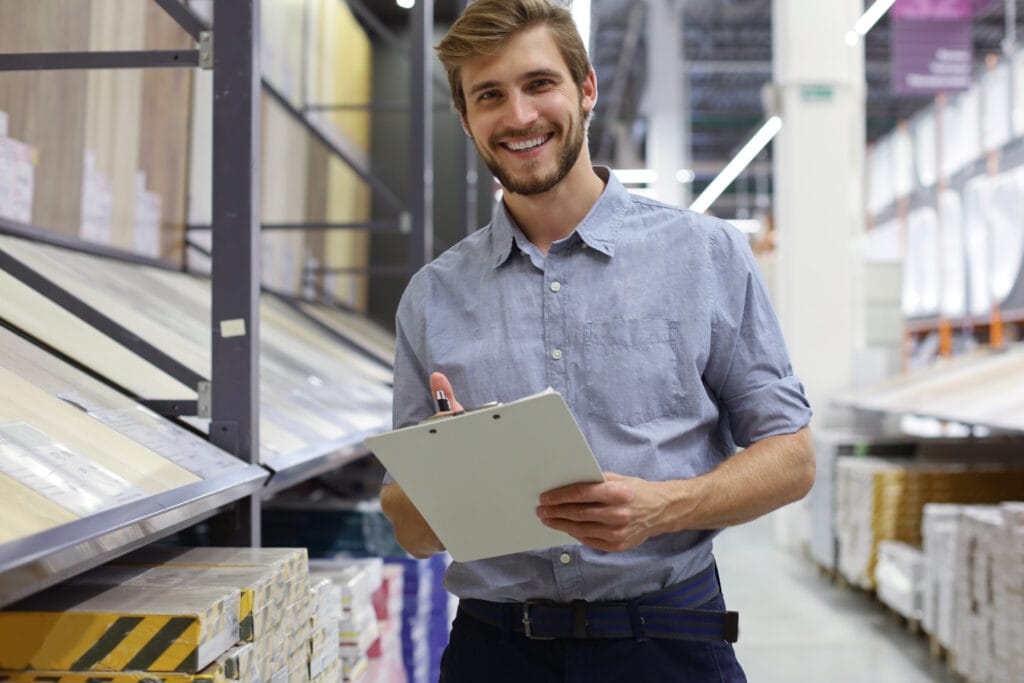 person in a flooring warehouse with clipboard | Classic Flooring Center